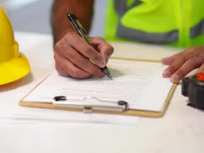 A builder on site, marking up a docket