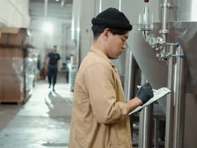 An inspector checking plant on the factory floor